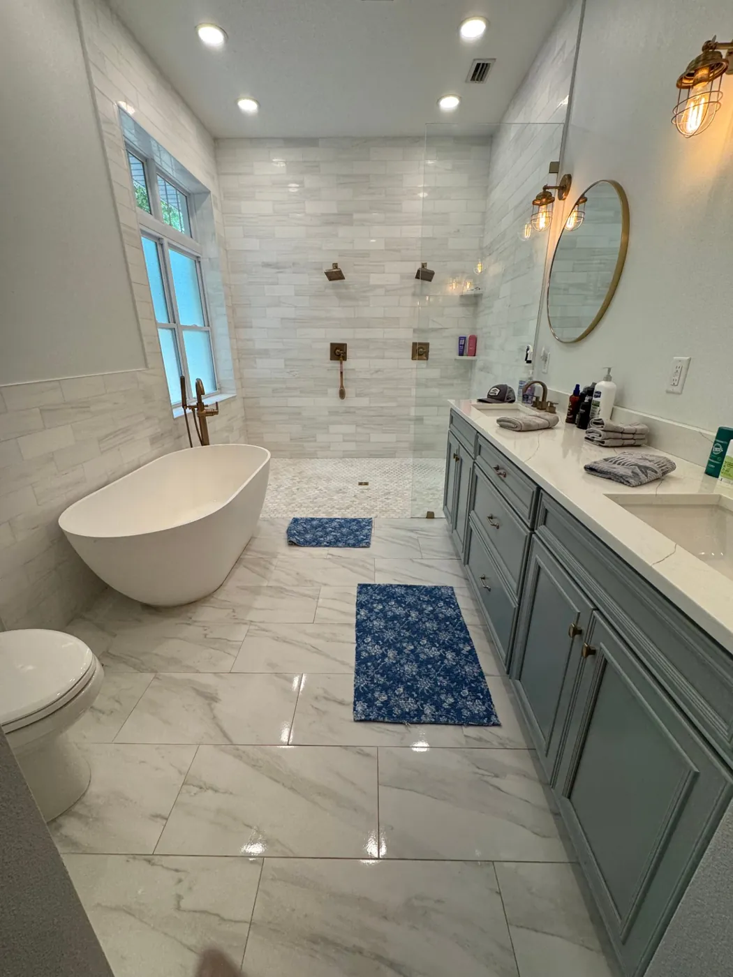 Master bathroom with polished marble tile and spotless shower glass