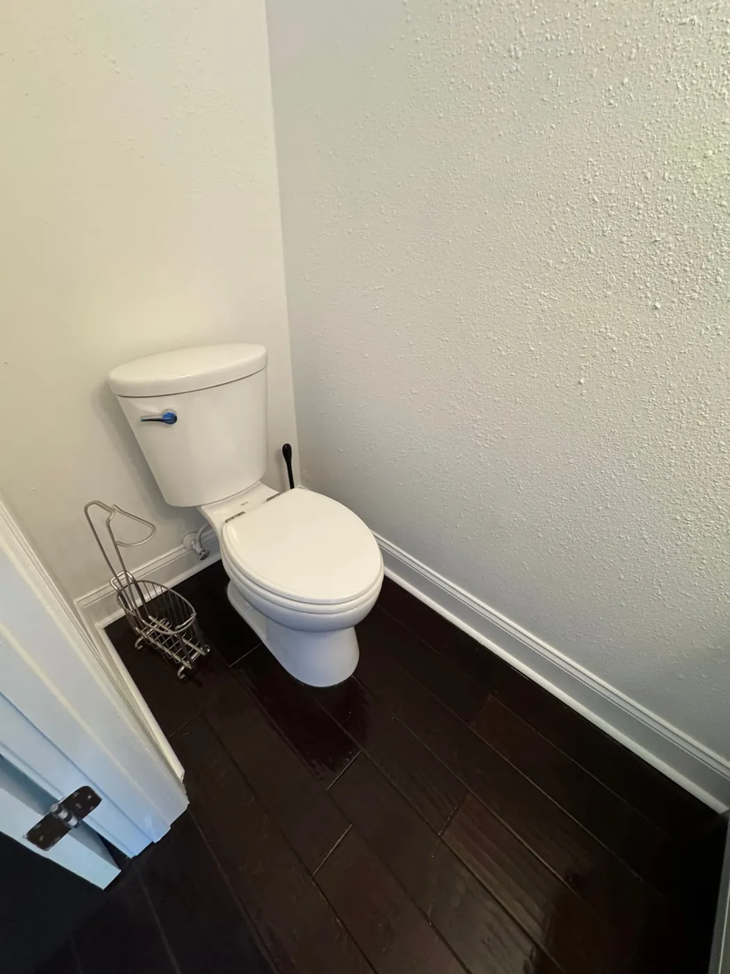 Powder room sanitized with polished dark wood floors