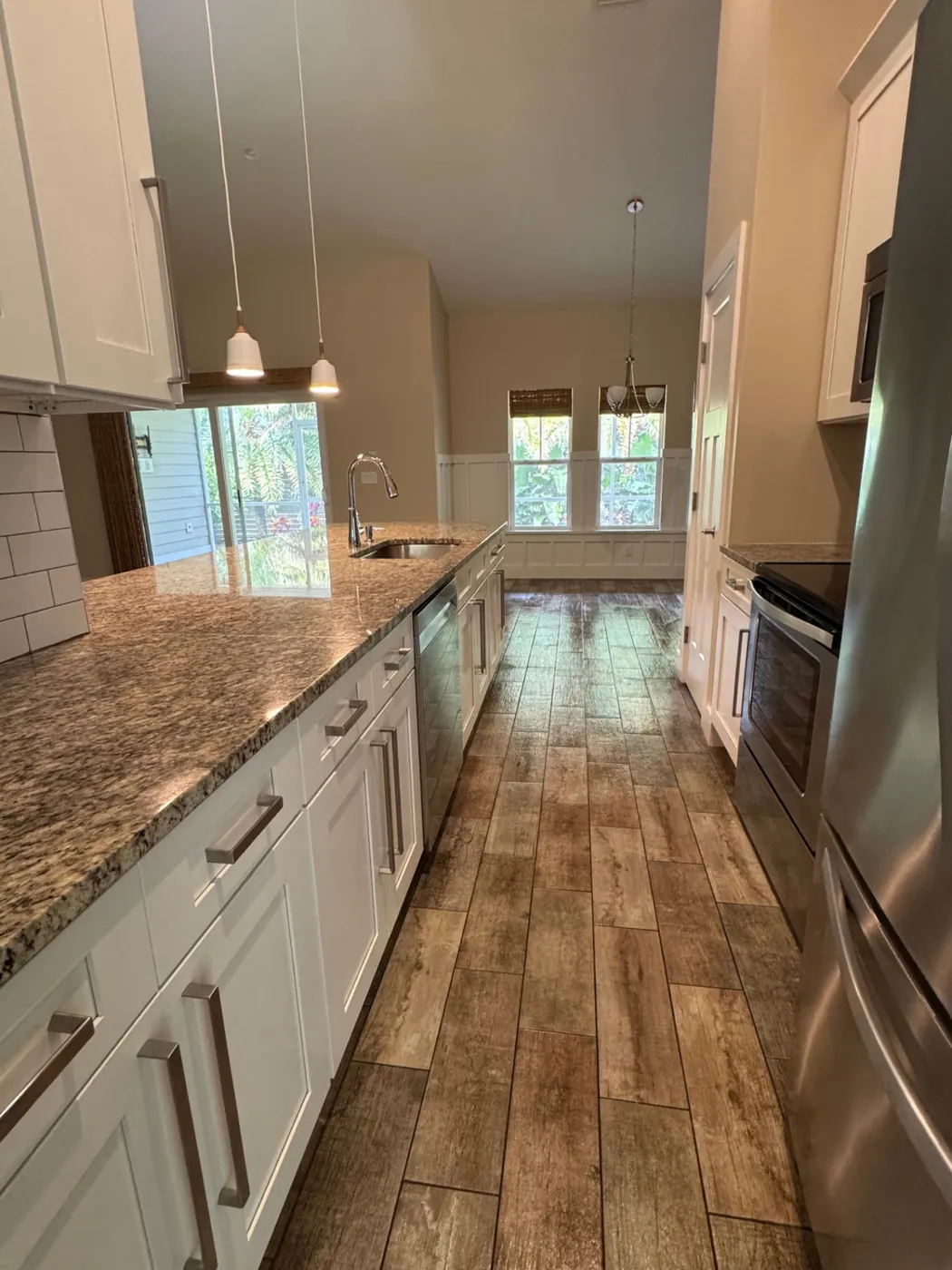 Galley kitchen with detailed granite counters after a deep cleaning