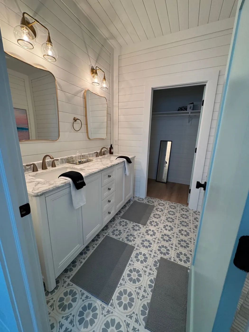 Bright master bathroom with double vanity staged with fresh towels